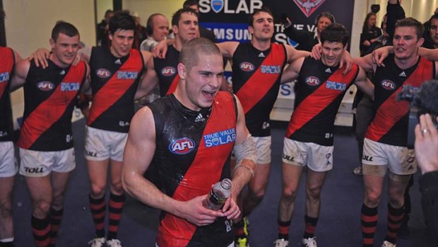 Loud and proud: Essendon's David Zaharakis in the middle of the club's celebrations after the win over the Western Bulldogs.