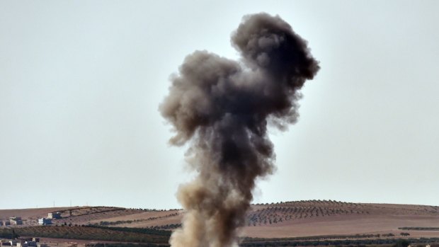 Smoke rises from an air strike on the outskirts of Kobane. Islamic State has taken a third of the town.