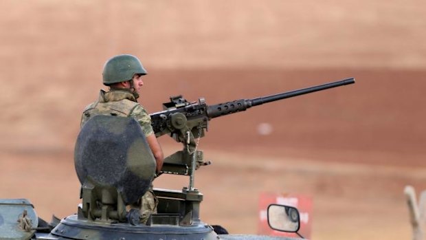 A Turkish soldier guards the Syrian border.