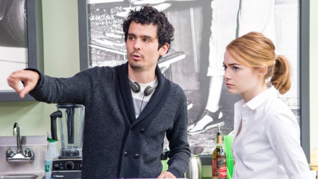 Director Damien Chazelle with Emma Stone on set.