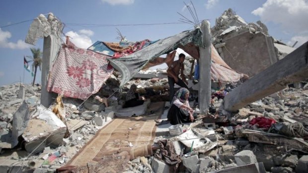 Palestinians shelter amid the rubble of their destroyed house in the town of Khan Younis in the southern Gaza Strip.