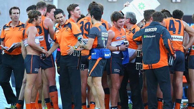 Another loss on the way: GWS players and coaches gather during a break in the game against the West Coast Eagles.