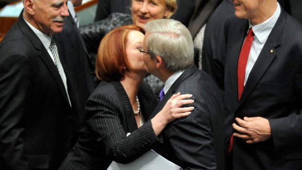 Prime Minister Julia Gillard hugs and kisses foreign minister Kevin Rudd after the carbon tax legislation was passed in the House of Representatives.
