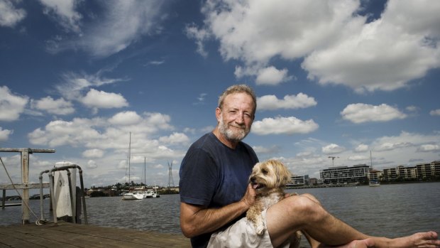 Author Frank Robson with his dog, Lucky, beside the Brisbane River at Bulimba.