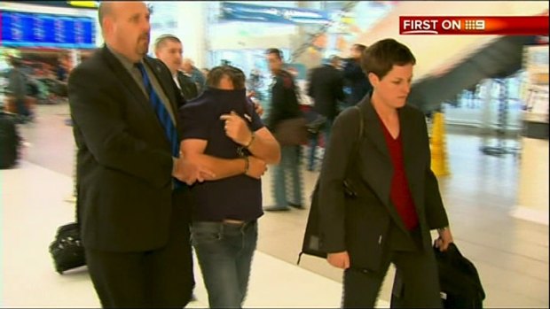 NBN Screengrab of  Jonathan Stenberg being extradited to Sydney after being arrested in Darwin's rural outskirts .