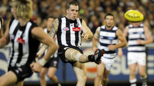 Dane Swan gets a kick away against the Cats.