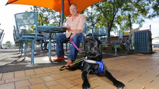 John Quilligan, with his dog Umali, says blind people are discriminated against daily.