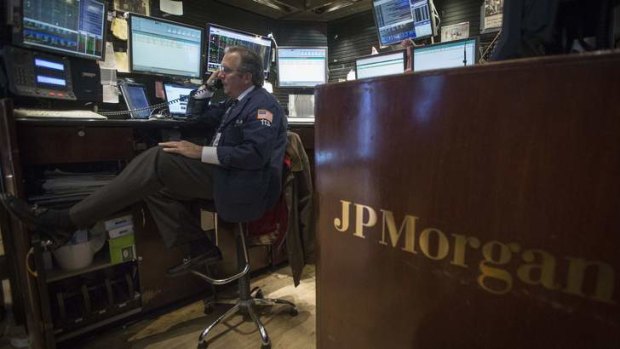 Billion dollar payout: a trader works at the JP Morgan stall on the floor of the New York Stock Exchange