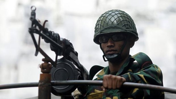 Uneven contest: A soldier keeps watch on polling day in Dhaka.
