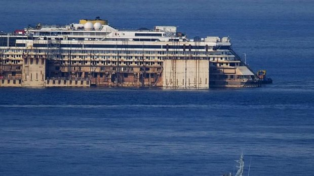The wreck of the Costa Concordia cruise ship is towed to the scrapyard.