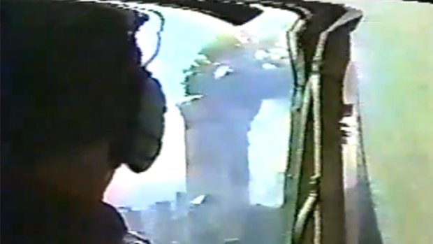 A NYPD helicopter pilot looks on as he circles the burning skyscrapers.