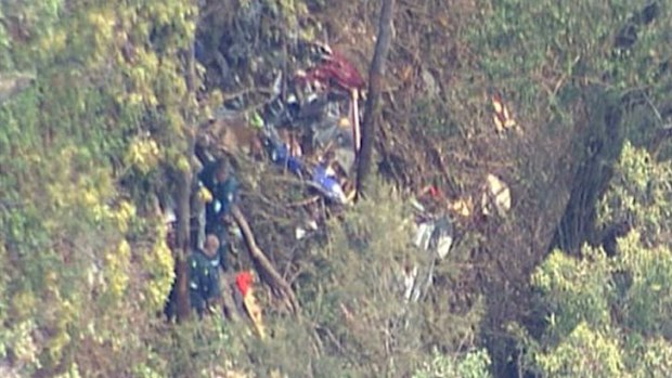 Rescue crews arrive at the wreckage of the vintage plane.