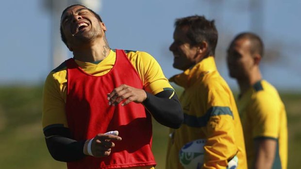 Ready, willing and in good spirits ... Wallaby Digby Ioane, his surgically repaired thumb in a bandage, enjoys a laugh during a World Cup training session at New Zealand's Saxton Park Oval.