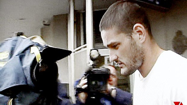 The media greets Fevola as he leaves a Brisbane lock-up.