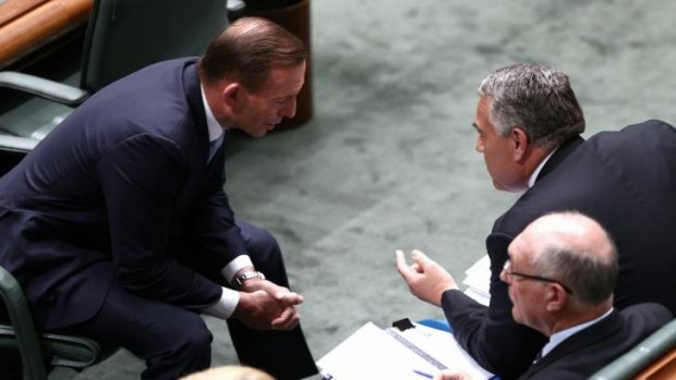 The PM consults with Joe Hockey during Question Time. 