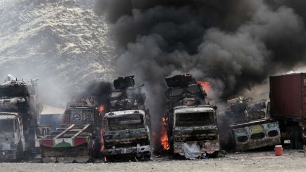 Deadly force: Smoke rises from  NATO supply trucks following an attack by militants in the Torkham area near the Pakistan--Afghanistan border in Jalalabad province east of Kabul, Afghanistan on Monday.