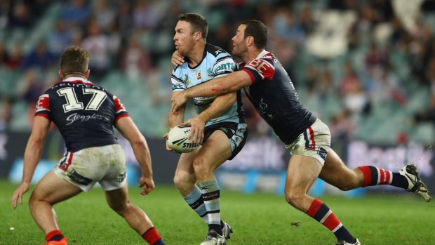 James Maloney of the Sharks is tackled by Boyd Cordner of the Roosters during their July clash.