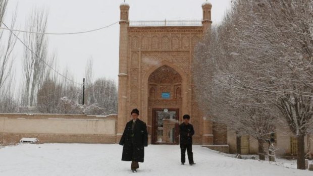 Tense region: Uighur men walk out of a mosque in Ujme township, Xinjiang.