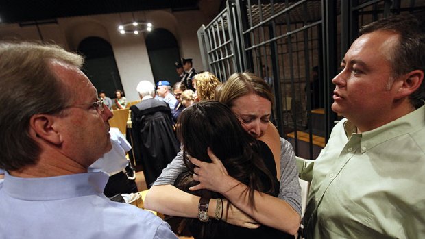 Relief ... Amanda Knox's father Curt Knox (L) and step-father Chris Mellas (R) watch asher mother Edda Mellas and sister Deanna embrace after the verdict.