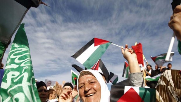 Palestinians celebrate the prisoner swap deal reached between Israel and Hamas outside Ofer prison near the West Bank city of Ramallah.
