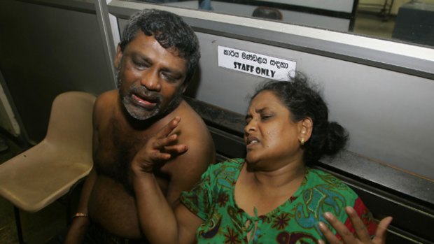 A Sri Lankan couple weep for their daughter, who was having surgery after being injured in an air attack by Tamil Tiger rebels on Colombo.