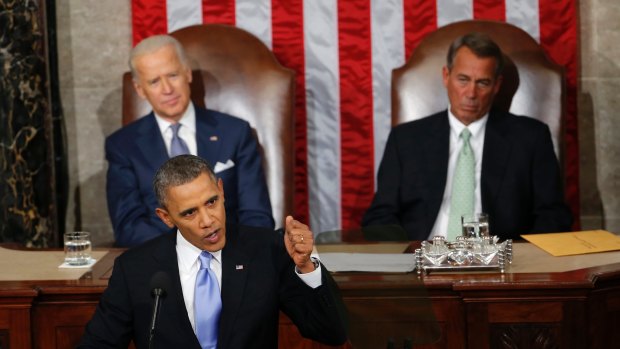 United States Vice-President Joe Biden, left, and House Speaker John Boehner listen as President Barack Obama gives his State of the Union address in Washington. 