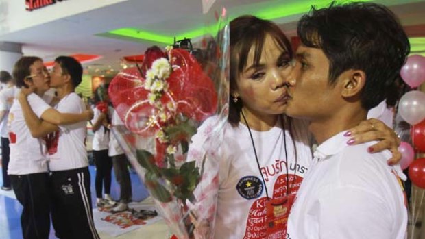 Participants Bunthawee Sengwong and Kanchana Kaetkaew kiss during an attempt in Pattaya to break the world record for the longest kiss.