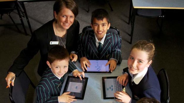 Pads out: Teacher Kate Hughes and her year 4 students at St Leonard's College, Brighton East. The school has embraced e-learning, using iPads in class with a student code of conduct in place after a six-month trial last year.