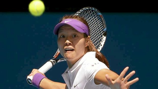Former Australian Open finalist Li Na of China hits a return to Agnieszka Radwanska.