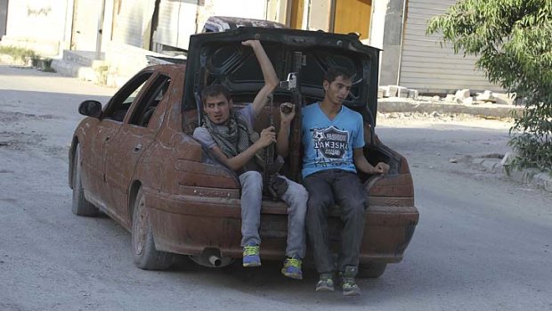 Heading to the front: Free Syrian Army fighters hit the road in Aleppo.