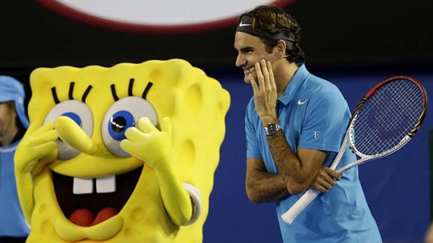 Righty-ho, Bob: Swiss superstar Roger Federer jokes with cartoon character SpongeBob SquarePants during Saturday's Kids Tennis Day at Melbourne Park.