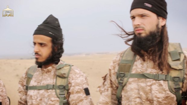 Members of IS from the execution video of Syrian soldiers and US aid worker Abdul-Rahman "Peter" Kassig. The man on the right is believed to be French citizen Maxime Hauchard. The man on left is unidentified.