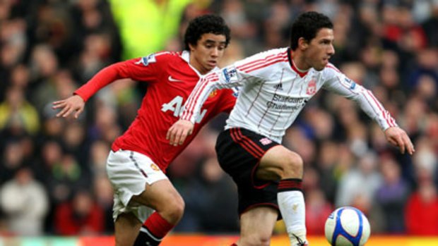 Tussle ... Rafael of Manchester United and Liverpool's Maxi Rodriguez.