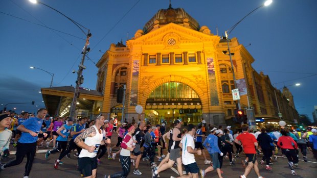 Thousands of runners make their way around the circuit of The Age Run Melbourne.