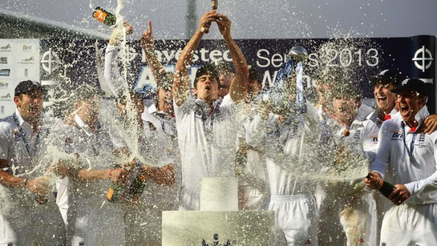 Alastair Cook of England lifts the urn at the Oval in August.