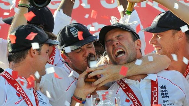 England player Graeme Swann (2/L) kisses the Ashes trophy as captain Andrew Strauss (L), Jonathan Trott (2/R) and Andrew Flintoff (R) enjoy the moment after England defeated Australia to win the Ashes in 2009.