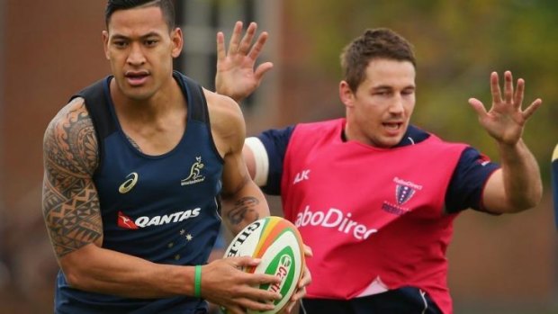 Hands off Folau: the Waratahs fullback during Wallabies training session at Scotch College in Melbourne on Thursday.