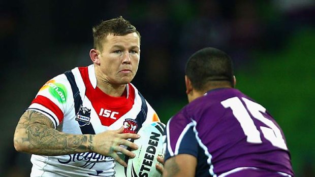 Todd Carney of the Roosters attempts to sidestep Sika Manu of the Storm during Monday nigh's game.