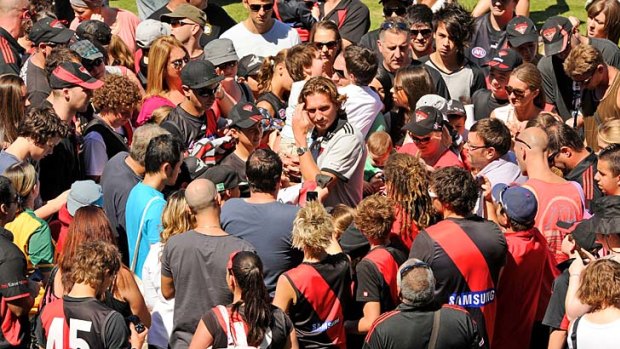 Essendon's coach James Hird keeps the fans happy during family day.