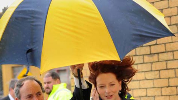 Julia Gillard braves the elements as she visits ARC steel in Sunshine. <i>Picture: Jason South</i>