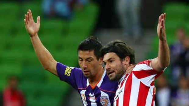 Melbourne Heart's Wayne Srhoj is challenged by Jacob Burns of Perth Glory during their round four A-League match.