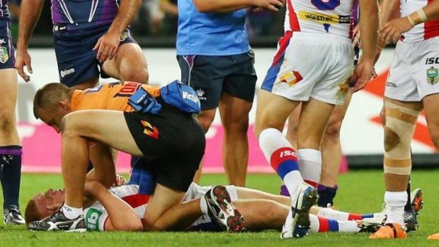 Alex McKinnon receiving medical attention after suffering the injury.