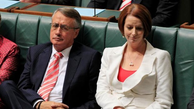 Prime Minister Julia Gillard and Treasurer Wayne Swan react to Tony Abbott's budget reply speech on Thursday.