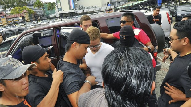 Dutch national Dylan Snel (centre, in white) is escorted by police as he arrives at court in Kota Kinabalu, in eastern Sabah state on Borneo island, Malaysia.