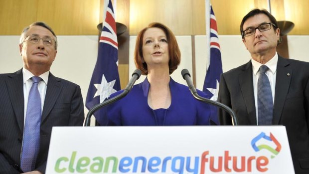 Prime minister Julia Gillard with treasurer Wayne Swan, left, and minister of climate change Greg Combet, right.