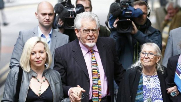 Dark side: Entertainer Rolf Harris arrives with his daughter, Bindi, and wife, Alwen Hughes, at Southwark Crown Court in London
