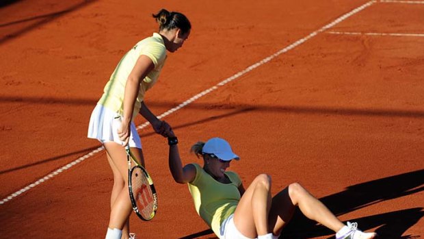 Falling flat: Jarmila Groth helps Anastasia Rodionova during their doubles loss.