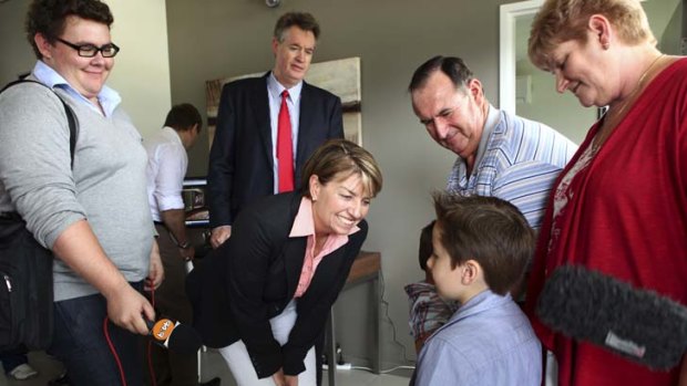 Welcome home &#8230; Premier Anna Bligh greets the Mahon family, the first to move to a new flood-proof estate above Grantham.