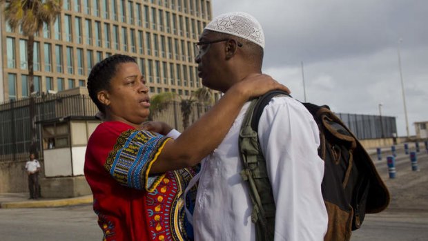 Justice delayed: William Potts says goodbye to his wife Aime Quesada outside the US Interests Section before he was escorted to the airport.