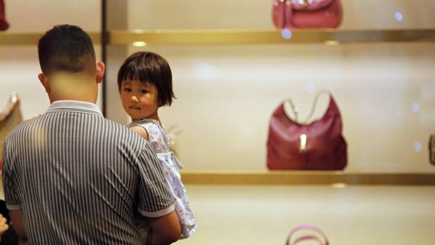 Growing market: A man and his daughter in a Gucci shop in Shanghai.